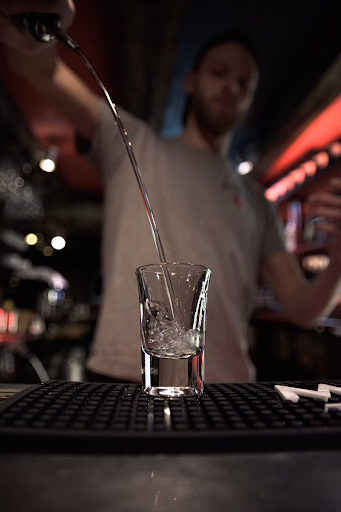 Man pouring a shot of vodka
